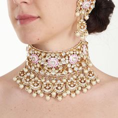 This exquisite Gold Plated Kundan with Pearl and Pink Meena Design Bridal Necklace set features a stunning Jadtar Kundan stone design, meticulously made from silver alloy and elegantly gold plated with 22kt gold. The intricate pink Meena work and delicate pearls enhance its beauty, making it a perfect accessory. Accompanied by matching statement earrings, this necklace set is designed to elevate your bridal look, ensuring you shine with elegance and sophistication on your big day. Composition: S Wedding Bridal Necklace With Gota Work In Chandbali Shape, Wedding Bridal Necklace With Gota Work, Wedding Temple Jewelry Sets With Gota Work, Temple Jewelry Sets With Gota Work For Wedding, Meenakari Bridal Sets For Reception And Diwali, Kundan Bridal Earrings With Zari Work For Reception, Temple Style Bridal Necklace For Reception With Gota Work, Bridal Necklace With Gota Work For Diwali Reception, Diwali Bridal Necklace With Gota Work For Reception