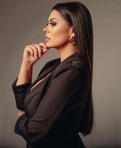 a woman with long hair posing for the camera