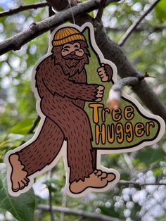 a tree hugger ornament hanging from a tree