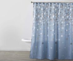 a blue shower curtain with snowflakes on it