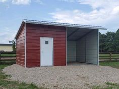 a red metal building with a white door