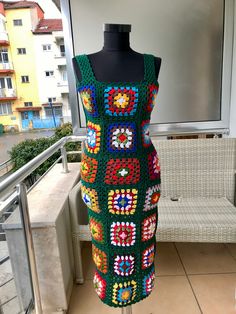 a crocheted dress is displayed on a mannequin