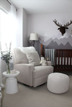 a baby's room with a deer head on the wall