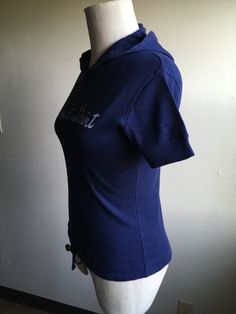 "1970s hooded short sleeve sweatshirt dark blue w/faded cursive lettering repaired at waist hem draw string waist worn in, small holes throughout soft and faded tag unreadable feels cotton, poly, or blend no size tag, measures most like an xxs/xs, flat, shoulder-13 1/2\" chest-16 (to 19) sleeve-6 1/2 length-22 1/2" Casual Blue Hooded T-shirt, Short Sleeve Cotton Hoodie With Drawstring, Streetwear Short Sleeve Tops With Drawstring Hood, Short Sleeve Tops With Drawstring Hood For Streetwear, Casual Short Sleeve Hoodie With Letter Print, Casual Short Sleeve Tops With Drawstring Hood, Blue Cotton Drawstring Tops, Sporty Short Sleeve Hoodie With Drawstring, 70s Shorts