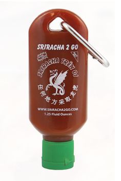 a ketchup bottle shaped like a keychain with a clip on it