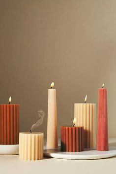 three candles are sitting on a plate next to each other