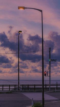 a street light sitting on the side of a road next to an empty parking lot