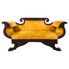 an old fashioned couch with yellow velvet upholstered on the back and armrests