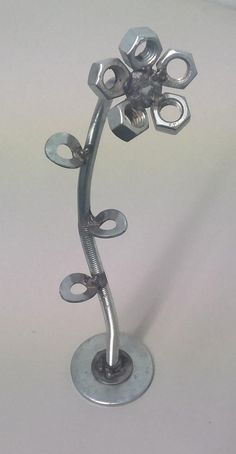 a metal flower sculpture sitting on top of a table