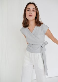 "SIZING & FIT This garment is true to size, and we recommend choosing the size you usually wear. If you want the garment to be loose-fitting, choose a larger size than you usually wear. Before placing an order, check the approximate measurements of the finished garment given below. Model is 5′6″ (170cm) tall with an 80cm/31″ bust, 68cm/26″ waist, 91cm/35″ hip, and she is wearing an XS in ice grey. XS Length ± 50cm | 19.7\" Bust ± 92cm | 36.2\" Sleeve length from neckline ± 14.5cm | 5.7\" Sle Sleeveless Wrap Top, Nursing Top, Summer Wardrobe Essentials, Nursing Tops, Grey Top, Top Sleeveless, Linen Top, Wrap Top, Fabric Scraps