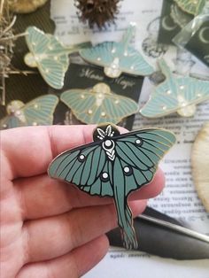 Luna moth enamel pin, subtle sage green and purple enamel with a polished silver finish. * Hard enamel Jewelry quality pin with a polished finish * 2 Post attachment with Butterfly OR Rubber Clutch. Handmade Green Enamel Brooches, Unique Green Enamel Pin, Unique Green Enamel Pin Gift, Green Enamel Pin Brooch For Gift, Green Enamel Brooch Pin As Gift, Green Brooch Enamel Pin For Gift, Butterfly-shaped Enamel Pin Gift, Butterfly Shaped Enamel Pin For Gifts, Green Enamel Brooch As Gift