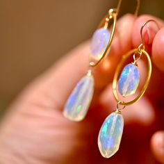 Atlantis Drops earrings are made woth gorgeous opals that look like they were formed from the magical waters of Atlantis. These opals display a blue hue with a rainbow flash inside. These have 4 spectacular opals and fhey are accenting with the finest gold vermeil hoops. Golden Circles - Gold Vermeil (over .925 sterling silver) Ethiopian Opals Top Opals: 12 x 9 mm Large Bottom Opals: - 18 x 9 mm 14 K Gold Filled Ear Wire Length: 2” Celestial Opal Gemstone Jewelry, Celestial Iridescent Dangle Jewelry, Iridescent Celestial Dangle Jewelry, Handmade Opal Drop Earrings, Hypoallergenic Opal Drop Earrings, Oval Opal Jewelry With Matching Earrings, Hypoallergenic Opal Dangle Jewelry, Iridescent Opal Round Jewelry, Iridescent Round Opal Jewelry