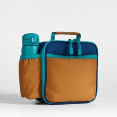 A fun and functional lunch box that's built to handle all the thrills and spills of the day. Combining colorblocks of navy and ocher with pops of aqua trim, our bag is constructed of food-safe and supremely durable polyester made from recycled water bottles. It's also lightweight and easy to clean, plus roomy enough to hold multiple storage containers. An insulated lining keeps meals just the way your kid likes them—hot, cold or somewhere in between. An outer pocket safely stows a napkin, utensi Functional Multicolor Lunch Box For Everyday Use, Blue Rectangular Lunch Box For Daily Use, Functional Multicolor Lunch Bag For Back To School, Portable Blue Lunch Bag For School, Durable Rectangular Lunch Bag For School, Functional Multicolor Lunch Box For Travel, Blue School Lunch Bag, Functional Multicolor Lunch Box For School, Functional Multicolor School Lunch Box