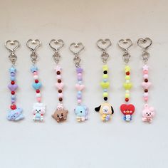 several keychains with various cartoon characters on them, all in different colors and shapes