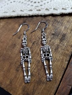 "Give a scare with the spooky detailed silver full body skeleton dangle earrings French hooks are hypoallergenic steel  Mr. Skeleton measures about 1.5\" in from head to toe **all of my charms are nickle and lead free  * your item arrives packaged and ready for gift giving  ** custom orders are always welcome simply message me Find more great Halloween jewelry in my shop !  Luxedesignsbysarah.etsy.com  Tags: Halloween jewelry, Halloween dangle earrings, silver skeleton earrings, silver bone earr Full Body Skeleton, Jewelry Vampire, Body Skeleton, Skeleton Jewelry, Vampire Jewelry, Skeleton Earrings, Jewelry Halloween, Dangle Earrings Silver, Bone Earrings