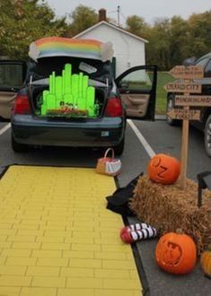 a car with pumpkins and decorations in the trunk