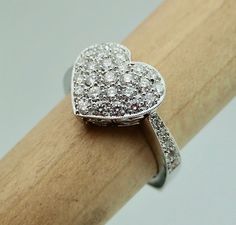 "This pave diamond heart shape ring is hand made in 18k white gold. There are 36 Pave set side diamonds totaling .76Cts, approximately 3/4 Carat The diamonds are VS clarity and G color range. We make all our own jewelry and focus on quality and durability. The ring is currently a size 6.25 you will be able to return it within the listed time frame for any reason at all. It will take 1-2 business days processing time. We can size it any size from 5 to 7 but it would be a FINAL SALE. It will take Diamond Heart Ring Hallmarked, Diamond Heart Cut Ring Hallmarked, Wedding Heart Ring With Hallmarked Diamond, Luxury Pave Setting Heart Ring For Anniversary, Heart Cut Diamond Ring With Pave Setting For Anniversary, White Gold Heart Cut Rings For Anniversary Gift, Elegant Heart Cut Rings For Anniversary Gift, Elegant Heart Cut Rings For Anniversary, Heart Cut Rings With Pave Setting For Gift