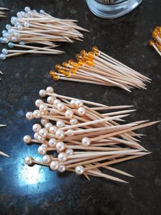 several toothpicks with beads on them sitting on a table