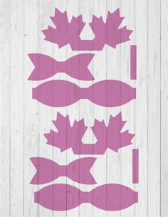 some pink and white leaves on a wooden wall with the words maple leaf stencils