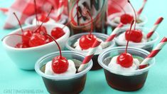 cherries are in small bowls on a blue and white checkered tablecloth with ice cream