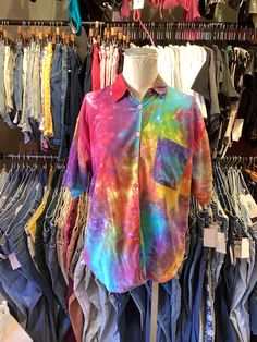 tie - dyed shirts are on display in a clothing store