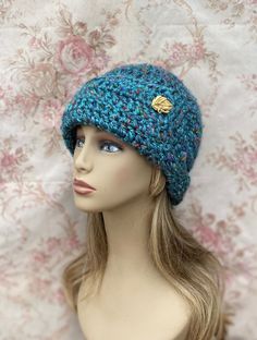 "⛄️⛄️⛄️ READY TO SHIP ⛄️⛄️⛄️ ❄️ This cloche style hat was hand crocheted in super thick soft Acrylic yarn.  This hat is a beautiful blue with specks of gold, green, blue, red, and orange throughout.   This hat will be warm and very soft against your skin. It is adorned with a vintage gold button.  ⛄️  I make my hats deeper than most, because of this they are perfect for women undergoing chemotherapy. They will cover your head well, and stay on. There are no irritating seams inside, and the yarn is soft.  ❄️  The hat has a lot of style and texture. It measures 22\" in circumference and stretches to 25\" comfortably. It is 10\" deep.  ❄️This hat will be super warm and fashionable for the cold weather.  💜Care instruction: Handwash and lay flat to dry for best results. Thanks for looking" Blue Crochet Beanie For Cold Weather, Blue Brimmed Hat For Winter, Blue Brimmed Winter Hat, Winter Hand Knitted Cloche Hat, Blue Crochet Beanie For Winter, Blue Crochet Yarn Hat For Winter, Blue Yarn Crochet Hat For Winter, Blue Winter Hat With Short Brim, Handmade Blue Beanie For Winter