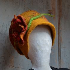 "A handmade stylish retro vintage style, slouchy felt beanie, a felted wool hat, to keep you warm and stylish this Fall/Winter time. It is made with mustard merino wool and a beautiful pure wool  vintage style fabric with flowers. To make this hat I have used the nuno-felting\" technique (felt and fabric). It is Made with pure merino wool, and  fabric.  merino wool fibers are spread thinly upon a fabric. The result is a light, soft and warm Hat.  To finish the look of this beanie I made a matchi Winter Felt Beanie Hat, Handmade Winter Felt Hat With Curved Brim, Handmade Felt Hat For Winter Gift, Handmade Hats For Fall Gifts, Handmade Wool Hat One Size, Handmade Winter Felt Hat In One Size, Handmade Felt Hat For Winter, Handmade Wool Felt Hat For Winter, Handmade Cloche Hat For Winter