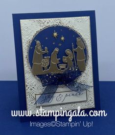 a christmas card with the nativity scene in blue and white, on a blue background