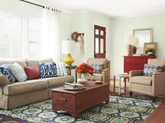 a living room with two couches and a coffee table in front of a window