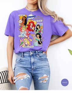 Step into the world of royalty with our Comic Princess Chic Tee! This whimsical t-shirt features your favorite princesses in a playful comic-inspired design. With vibrant colors and charming illustrations, this tee is perfect for adding a touch of magic to your wardrobe. Whether you're heading to a theme park or just want to feel like royalty, this tee is sure to make you feel like the belle of the ball! Cute Character Print T-shirt For Disney Fan Events, Fun Character Print T-shirt For Disney Fan Events, Disney T-shirt With Funny Print For Fan Events, Let Your Light Shine, Theme Park, Royalty, Vibrant Colors, Illustrations, Comics