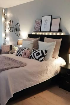 a bedroom with lights on the wall and a bed in it's centerpiece