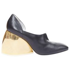 LOEWE gold curved heel black leather slip on heeled shoes EU39 Reference: ECLO/A00130 Brand: Loewe Designer: JW Anderson Collection: Runway Material: Leather, Metal Color: Black, Gold Pattern: Solid Closure: Slip On Lining: Black Leather Extra Details: Gold curved chunky heels. Made in: Italy CONDITION: Condition: Good, this item was pre-owned and is in good condition. Please refer to image gallery for thorough condition check. Multi scratches and stains on gold heels. Natural worn dents at top. SIZING Designer size: EU39 Size reference: EU39 / US9 / UK6 / JP26.5 This Loewe item is authentic. Loewe Shoes, Jw Anderson, Gold Heels, Gold Pattern, Jil Sander, Leather Slip Ons, Image Gallery, Giuseppe Zanotti, Black Heels