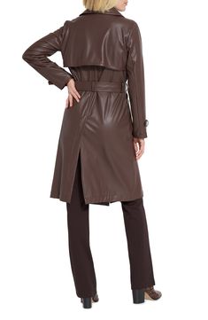 A water-resistant finish adds a utilitarian spin to a sleek faux-leather trenchcoat that's an outerwear style essential. 43 1/2" length Front button closure Notched lapels Belted cuffs Front button-flap pockets Gun flaps Removable tie belt Storm flap Back vent Water resistant 95% polyester, 5% spandex with polyurethane coating Machine wash, line dry Imported Sleek Brown Leather Outerwear, Belted Brown Outerwear For Business, Sleek Brown Business Outerwear, Sleek Belted Fall Outerwear, Sleek Belted Outerwear For Fall, Modern Faux Leather Outerwear For Work, Belted Faux Leather Long Coat, Brown Faux Leather Outerwear For Work, Belted Long Faux Leather Coat