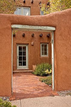 an adobe - style house is shown in the desert