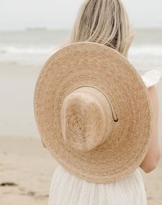 Handmade by artisans in Mexico, our new 100% raffia hats are a must-have for the warmer months. Featuring a tightly woven pressed palm design with a fedora crown, The Leon Palm Hat is the elevated essential you need for days under the sun. The wide brim and woven drawstring make this hat perfect for shade when your having a fun day at the the beach. 100% Raffia Ethically handmade in Mexico Inner elastic sweatband to help with fit Spot / specialist clean XS/S - Brim: 5 1/2" Inner Circumference: 2 Raffia Hats, Beach Hats For Women, Palm Design, Mama Bracelet, Raffia Hat, Sustainable Manufacturing, Summer Soiree, Feminine Power, Snake Necklace