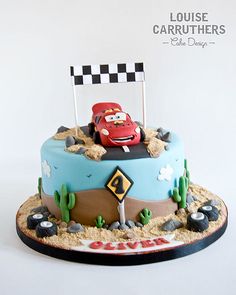 a birthday cake with cars on the top