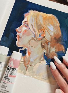 a woman's hand is painting a portrait with acrylic paint and glue