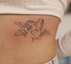 a woman with an angel tattoo on her stomach