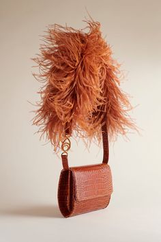 The Lijadu Bird Bag, now in Cognac Croc. The Cognac Croc comes with both a Candy Floss strap and a Cognac Croc strap. Wear as an over-the-shoulder, or remove the strap to wear as a clutch. You do you. Approximate dimensions: 8 inches x 7 inches; 23 inch strap; 2.5 inches wide Luxury Brown Flap Bag With Adjustable Strap, Evening Cognac Shoulder Bag With Removable Pouch, Formal Cognac Shoulder Flap Bag, Evening Bags With Detachable Strap In Cognac, Cognac Crossbody Flap Bag For Evening, Evening Satchel Shoulder Bag With Long Strap, Cognac Evening Bags With Detachable Strap, Evening Rectangular Cognac Flap Bag, Chic Formal Shoulder Bag With Long Strap