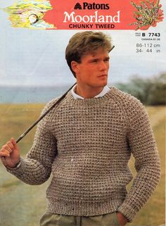 a man wearing a sweater and holding a baseball bat