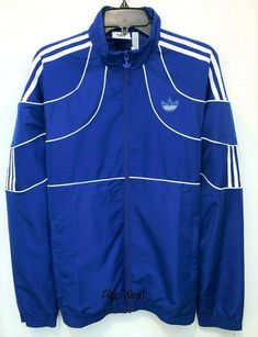 ADIDAS ORIGINALS ORIGINALS 2K TECH TRACK JACKET  Size: Small Color: Blue MSRP: $90 100% Authentic Guaranteed Football style from the 2000s inspires this men's track jacket. A Trefoil outline and geometric angles create a clean, minimalist design. Deconstructed contrast 3-Stripes are a fresh take on an iconic sporty look. - Funnel neck - Long sleeves - Front zip closure - Piping trim - 3-stripe and logo details - Dual front pockets - Lined - Imported Machine wash 100% polyester Measurements: plea Technical Moisture-wicking Track Jacket For Streetwear, Sportswear Nylon Track Jacket With Adidas Logo, Adidas Moisture-wicking Track Jacket For Streetwear, Adidas Nylon Track Jacket For Streetwear, Adidas Nylon Track Jacket, Adidas Technical Track Jacket For Streetwear, Blue Nylon Track Jacket For Spring, Adidas Functional Nylon Track Jacket, Athleisure Nylon Track Jacket With Three Stripes Branding