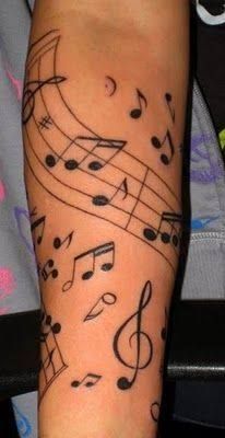 a person's arm with musical notes on it