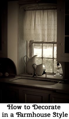 a pitcher sitting on top of a kitchen sink next to a window