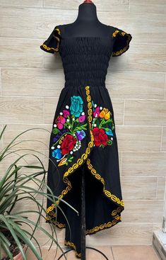 This beautiful dress is the perfect style to attend a Mexican party, with beautiful floral embroidery, has a spring at the waist to adjust the figure and a ducktail design. This dress is one size and fits S/M. Handcrafted machine embroidered dress. Each dress has unique embroidery so colors may vary. We ship anywhere in the word, from Tepic, Nayarit,  mx. Made by artisans from Oaxaca, Mx We recommend washing by hand with cold water, tender in the shade, to better preserve the original color. Embroidered Summer Party Dress, Asymmetrical Hem Maxi Dress For Garden Party, Midi-length Embroidered Dress For Garden Party, Embroidered Midi Dress For Garden Party, Garden Party Midi-length Embroidered Dress, Garden Party Midi Dress With Embroidered Hem, Fitted Maxi Dress With Asymmetrical Hem For Garden Party, Fitted Multicolor Embroidered Maxi-length Dress, Fitted High-low Midi Dress For Summer