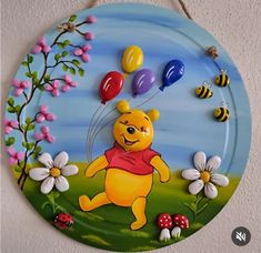 a winnie the pooh wall hanging with balloons and flowers