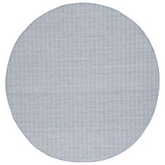 a round rug with white dots on it