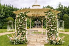 the gazebo is decorated with flowers and greenery