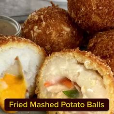 fried mashed potato balls on a plate with dipping sauce