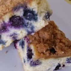 two pieces of blueberry cheesecake on a plate