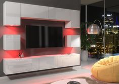 a modern living room with white furniture and red lighting on the tv screen, in front of a cityscape at night